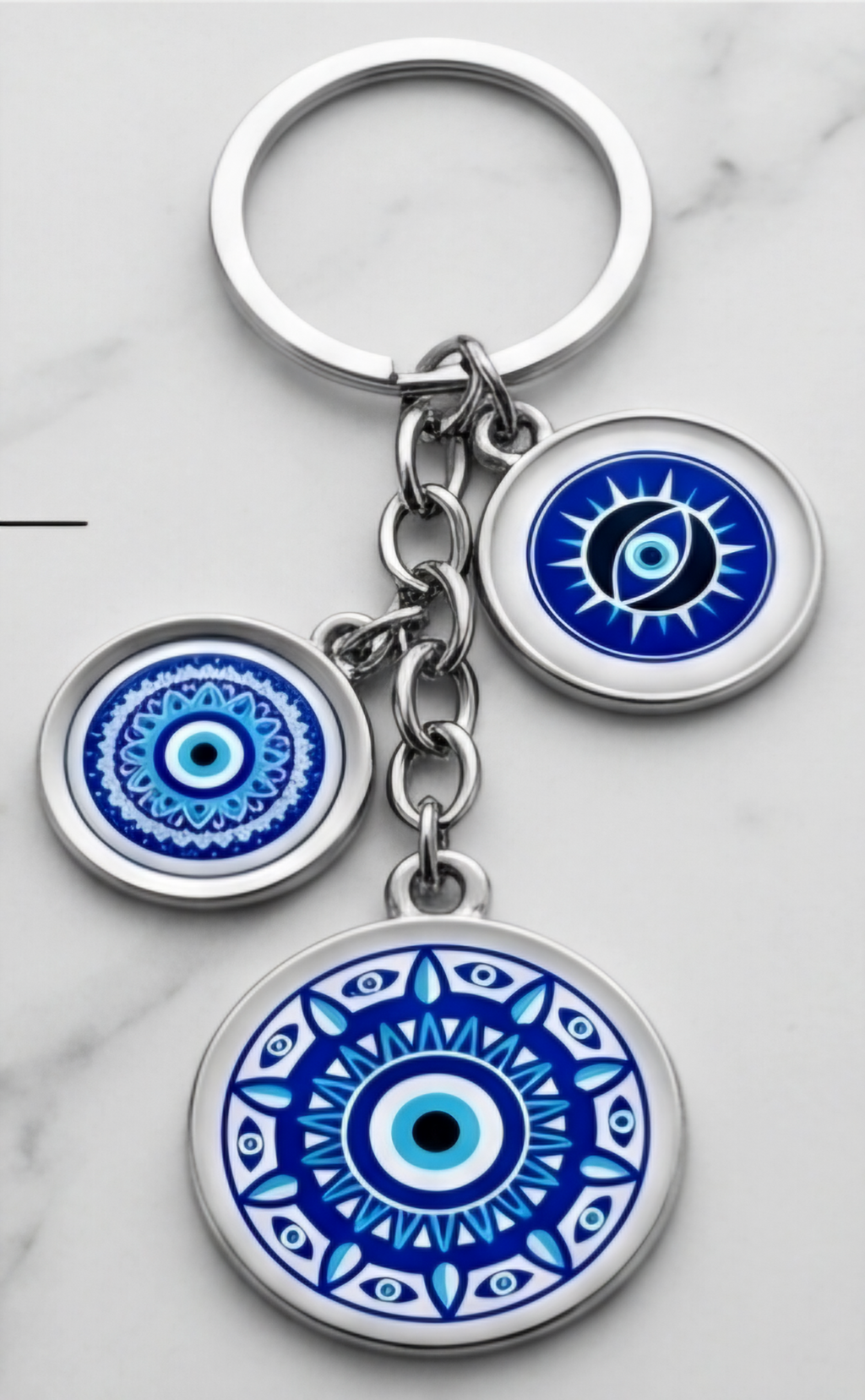 Keychain with blue and white circular designs on a marble surface